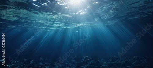 Dark blue ocean surface seen from underwater. sun light rays under water