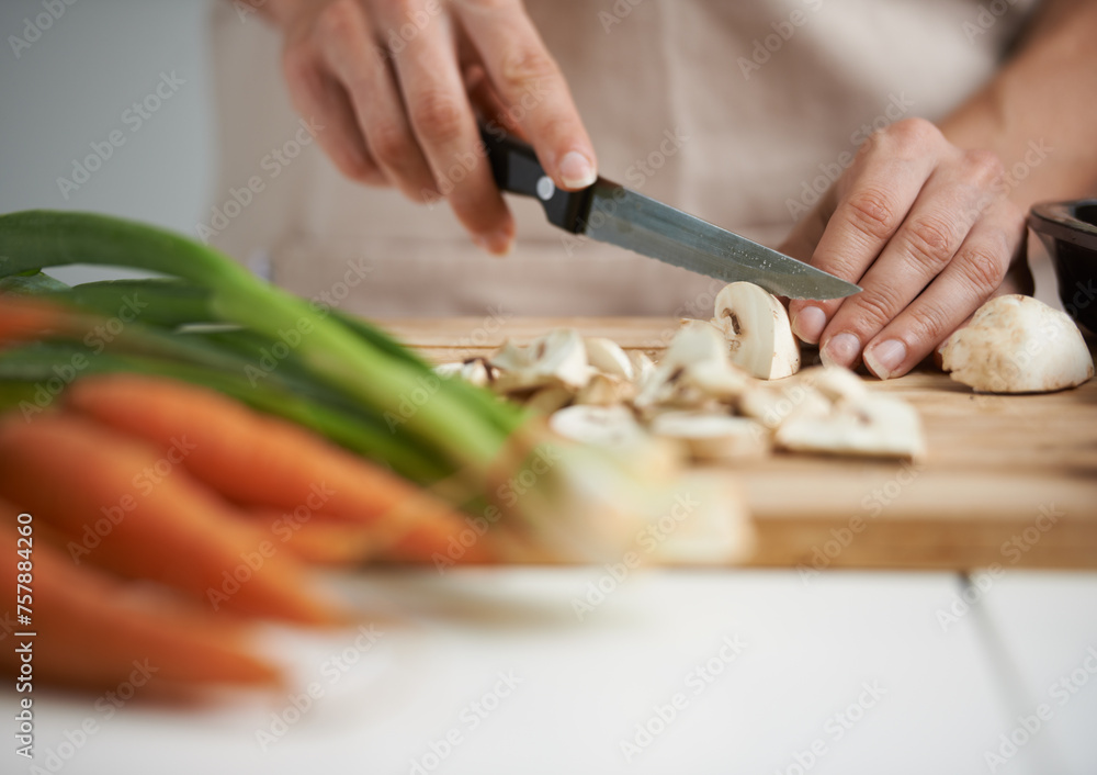 Cooking, food and hands with vegetables in kitchen on wooden board for cutting, meal prep and nutrition. Healthy diet, ingredients and person with mushrooms for vegetarian dinner, lunch and salad