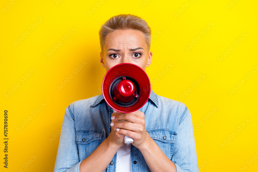 Obraz premium Photo portrait of pretty young girl hold megaphone strict order wear trendy jeans outfit isolated on yellow color background