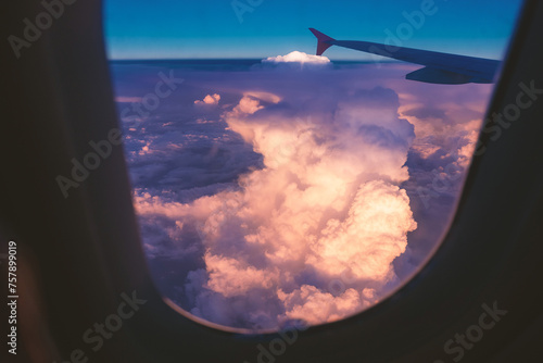 View from airplane window, sky and clouds at sunset or sunrise © bermuda cat