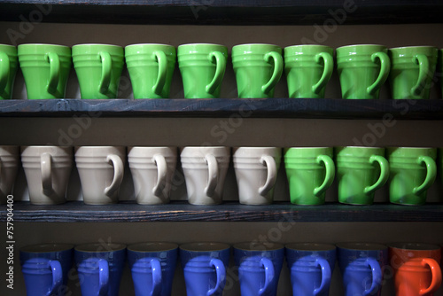 ceramic cups on the shelves photo