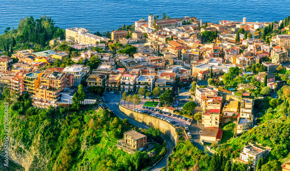 scenic view at beautiful mountain town on a sea coast in Italy with green hills, antique buildings and amazing blue sea on backgeound of landscape