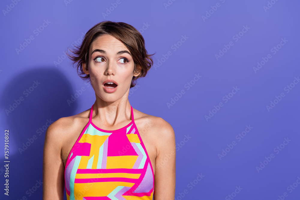 Portrait of confused shocked youngster girl open mouth wear trendy vibrant clothes look empty space isolated on purple color background Portrait of confused shocked youngster girl open mouth wear trendy vibrant clothes look empty space isolated on purple color background