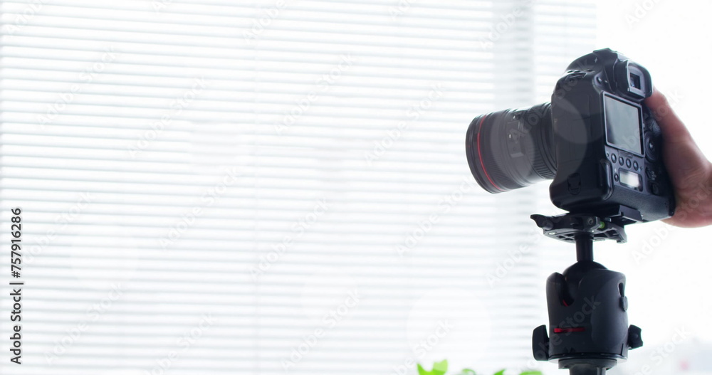 White spots floating against mid section of a man placing a digital camera on a tripod White spots floating against mid section of a man placing a digital camera on a tripod