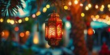 A warm, glowing traditional lantern hangs amidst twinkling lights, capturing a festive atmosphere in an outdoor setting.