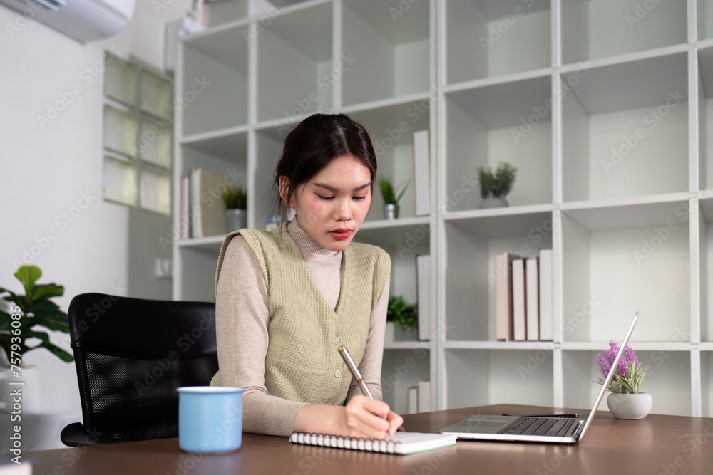 Woman asian creative in home office and laptop for research in remote work, social media or blog in apartment. Freelance at desk with computer writing email, website post and online chat in house Woman asian creative in home office and laptop for research in remote work, social media or blog in apartment. Freelance at desk with computer writing email, website post and online chat in house