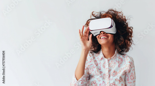 Young amuzed smiling woman wearing VR glasses photo