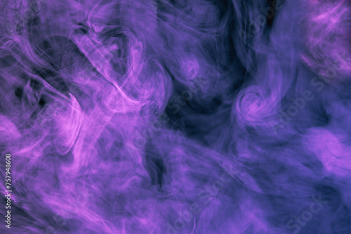 Purple with shades of blue smoke on a dark black background. Beautiful abstract colored background.