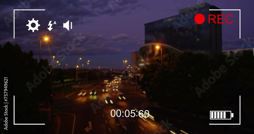 Image of night traffic in fast motion, seen on a screen of a digital camera in record mode with icon