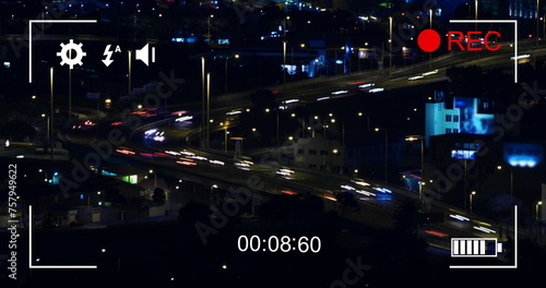 Digital camera records fast-moving night traffic and cityscape in 4k.