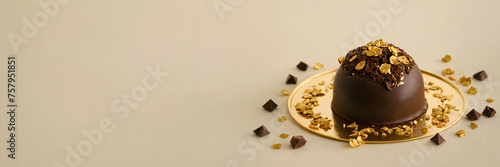 Chocolate truffles on golden plate with chocolate pieces and chocolate pieces on beige background