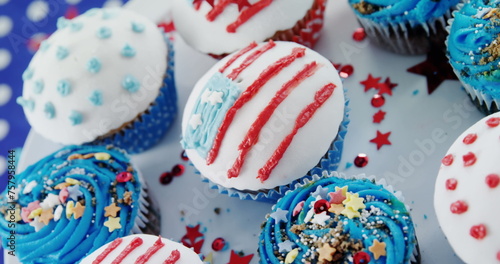 Image of usa flags and white and red stripes over cupcakes