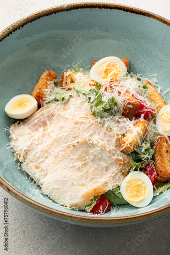 Portion of gourmet caesar salad with chicken photo