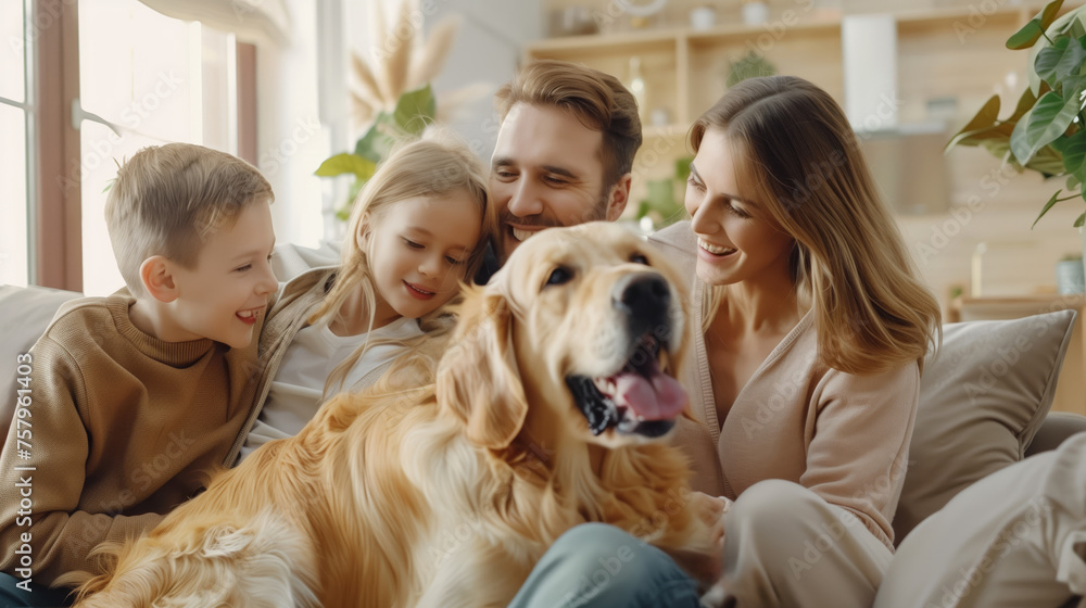 A happy smiling family next to their dog, smiling and playing at home