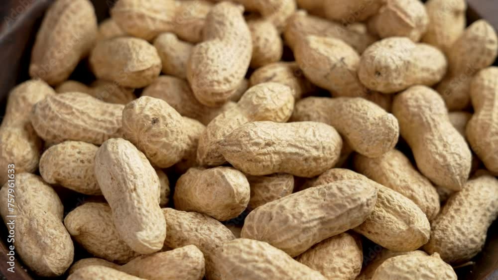 Peanuts pods in shell. Full rustic bowl of crunchy nutritious ingredient. Rotation Peanuts pods in shell. Full rustic bowl of crunchy nutritious ingredient. Rotation