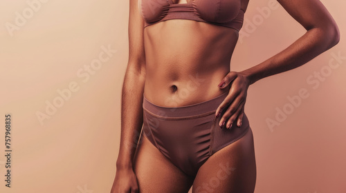 Elegance in Fitness - Sleek Sportswear on a Woman s Torso Against a Soft Pink Background