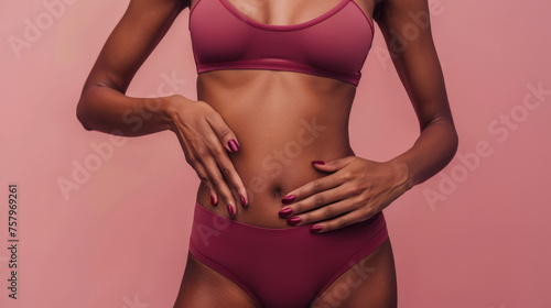 Elegance in Fitness - Sleek Sportswear on a Woman's Torso Against a Soft Pink Background © Farnaces