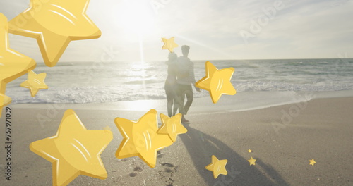 Image of stars over biracial couple at beach