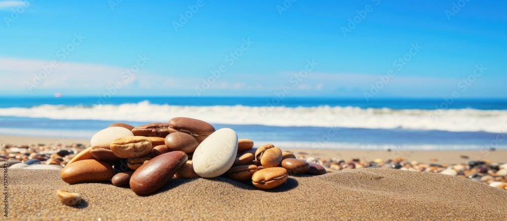 Stunning Seascape: Rocks Scattered on Peaceful Seashore Highlight Natural Beauty