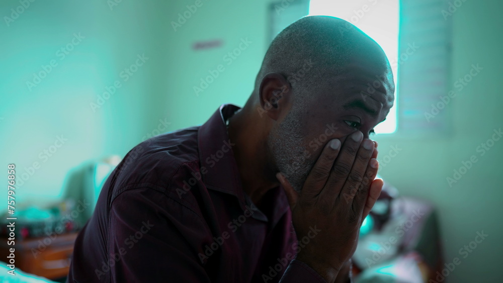 Close-Up Portrait of an African American Elder Coping with Emotional Distress in a Dimly Lit Room, Overcome with Feelings of Regret and Shame, middle-aged man struggles with depression Close-Up Portrait of an African American Elder Coping with Emotional Distress in a Dimly Lit Room, Overcome with Feelings of Regret and Shame, middle-aged man struggles with depression
