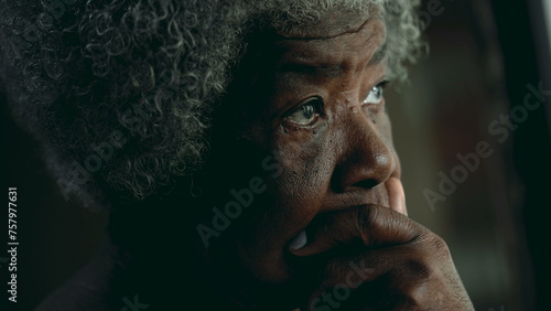 Contemplative African American elderly woman gazing out in the distance in deep mental reflection. One black lady thoughtful expression pondering solution