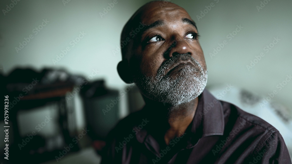 Desperate African American Senior Man in Deep Thought, Struggling with Sadness and depression in Moody Bedroom, Dramatic Portrait gazing at window feeling quiet despair Desperate African American Senior Man in Deep Thought, Struggling with Sadness and depression in Moody Bedroom, Dramatic Portrait gazing at window feeling quiet despair