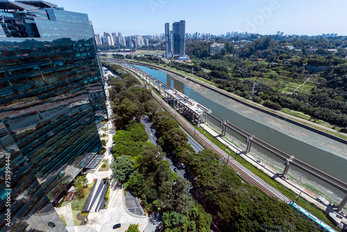 Aerial view of the polluted Pinheiros River next to expressways and modern buildings. Sao Paulo, Brazil