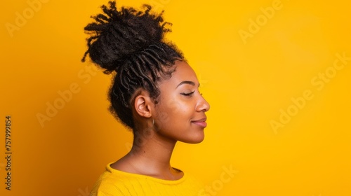 Afro girl with big bun haircut, isolated orange background