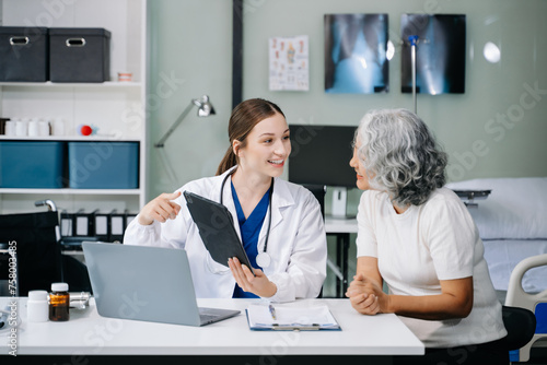 Portrait of female doctor explaining diagnosis to her patient. Doctor Meeting With Patient In Exam Room. A medical practitioner reassuring a patient .