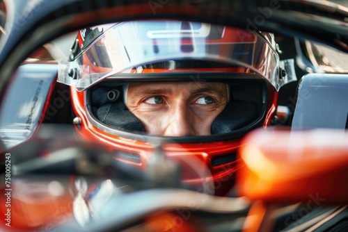 man wearing a helmet in a racing car © Elena