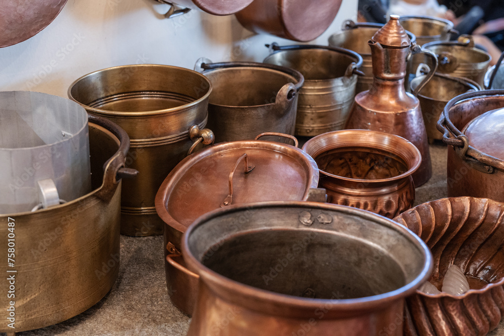 Copper Pots and Pans and other Kitchen Utensils in an Antique Kitchen. Copper Pots and Pans and other Kitchen Utensils in an Antique Kitchen.