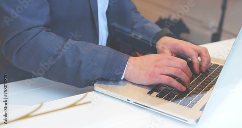 Image of fingerprint over caucasian businessman using laptop