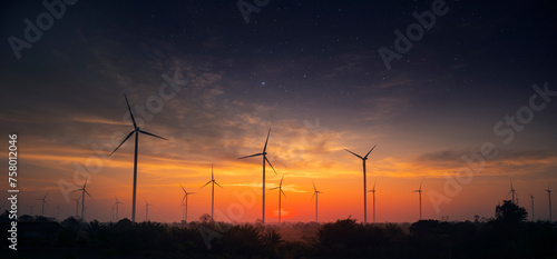 Electric wind turbine farm in the morning and starburst.wind energy, Electricity production plant. High voltage transmission. Environmentally friendly. panoramic landscape.