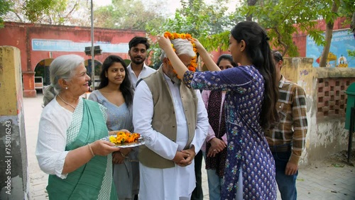 Political party supporters welcoming the political party leader with flower garland - public servant  the Indian government  lok sabha member. A politician being congratulated for the win in the el... photo