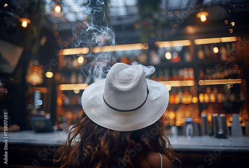 A woman wearing a straw hat sits at a bar with a cigarette in her mouth