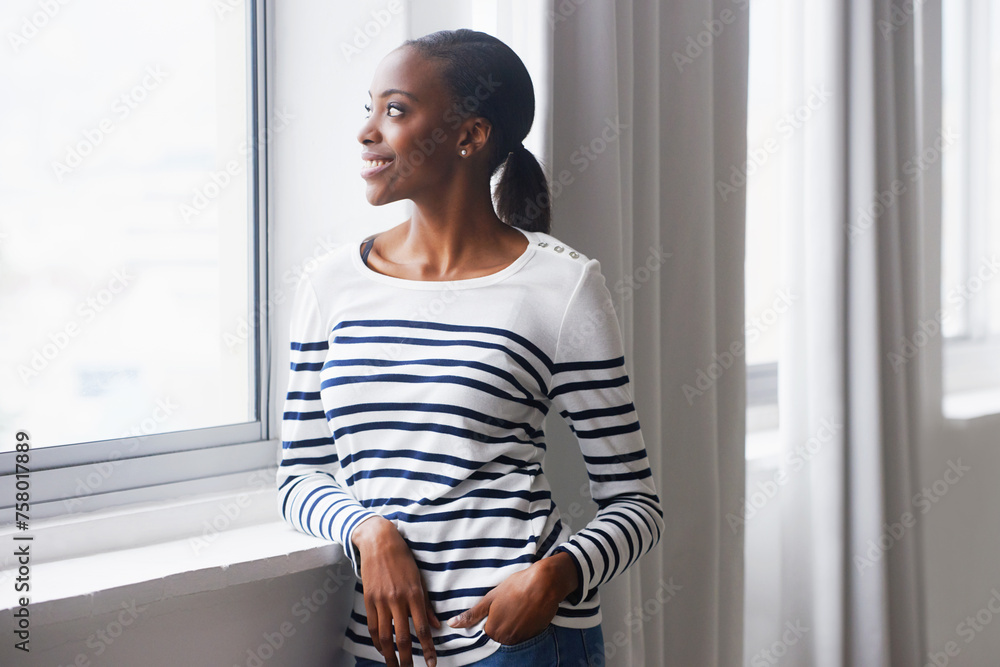 Woman, happy and thinking by window in new home with confidence for real estate investment and mortgage. African homeowner, person and thoughtful with future house ideas and relocation in living room Woman, happy and thinking by window in new home with confidence for real estate investment and mortgage. African homeowner, person and thoughtful with future house ideas and relocation in living room