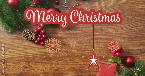 Image of merry christmas text over christmas decorations