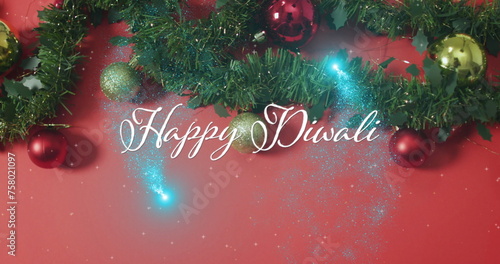 Image of happy diwali text over christmas decorations