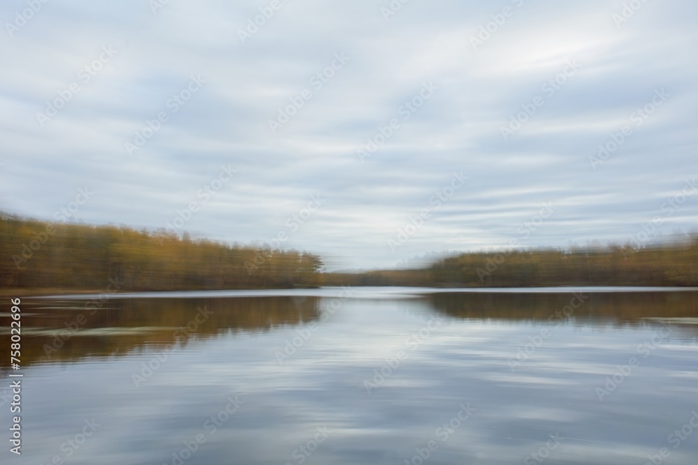 ICM Intentional camera movement with long exposure lake view in autumn abtract background.