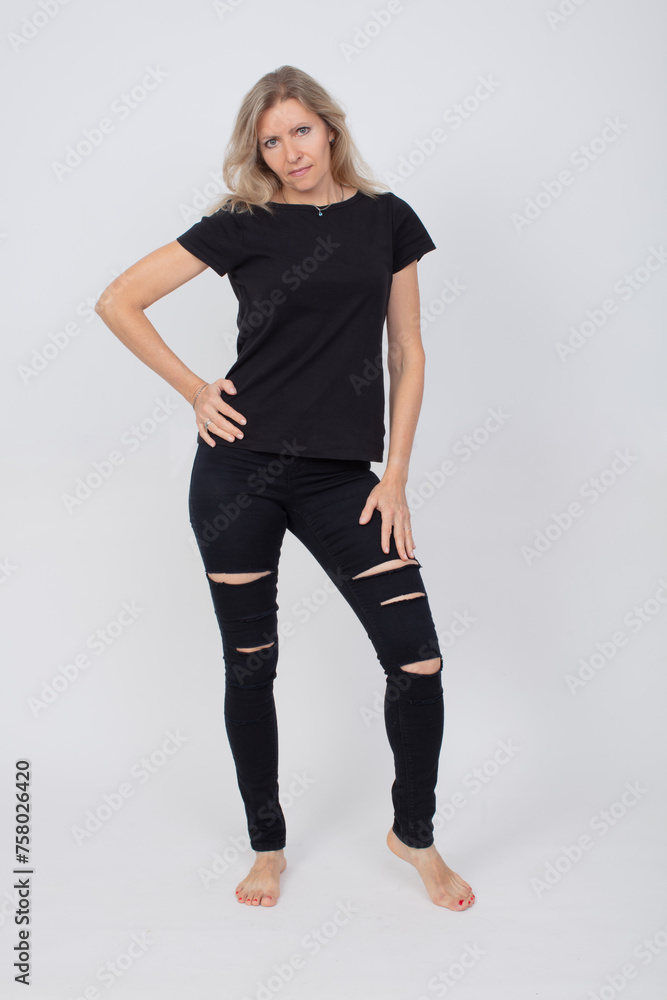 A beautiful full-length adult woman in stylish black jeans and a T-shirt. A beautiful full-length adult woman in stylish black jeans and a T-shirt.
