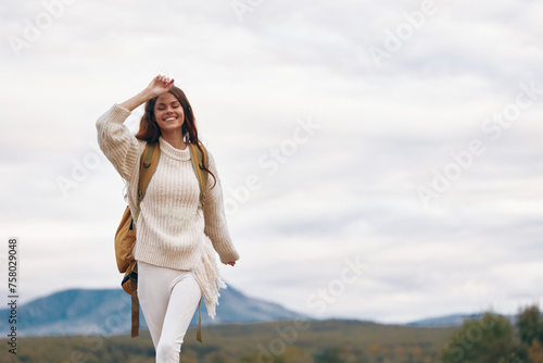 Wallpaper Mural Mountain Adventure: Smiling Woman Trekking to the Peak, Enjoying Nature and Freedom on a Cliff Torontodigital.ca