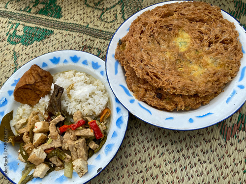 Indonesian traditional food of vegetable lodeh and crispy egg. photo