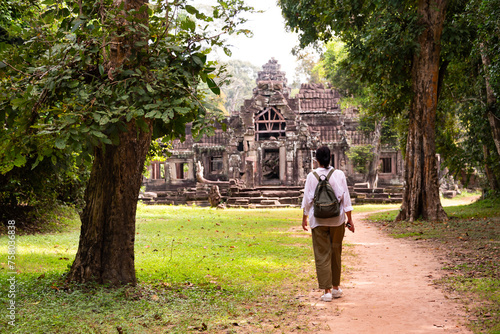 Wallpaper Mural Female tourist walking to ancient Angkor temple in Cambodia Torontodigital.ca