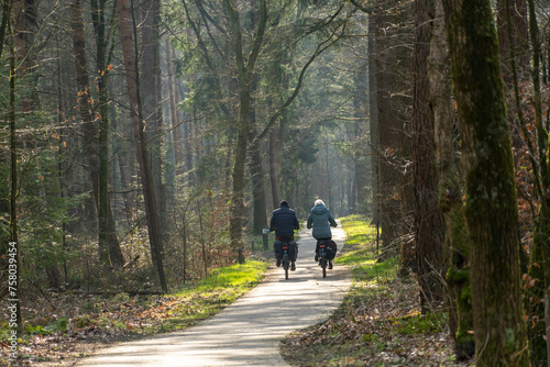 Senior couple bicycling in the forest of the city of Ermelo.