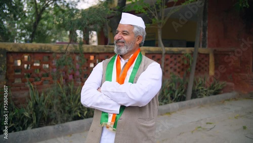 An Indian political party leader folding his hands and posing for the camera - assembly election  election winner  Indian democracy. A leader of the government party with a tricolour scarf strikes ... photo