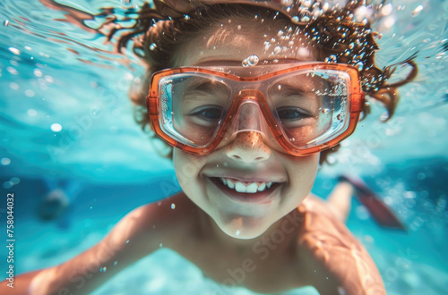 happy child swimming underwater in pool, closeup portrait, smiling and having fun at summer vacation
