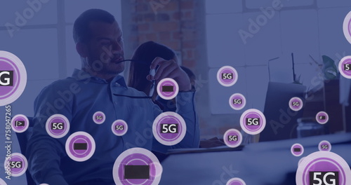 Image of network of connections with icons over caucasian businessman in office
