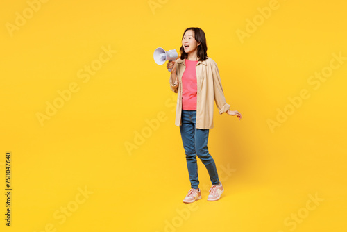 Full body young woman of Asian ethnicity wear pink t-shirt beige shirt casual clothes hold megaphone scream announces discounts sale Hurry up isolated on plain yellow background. Lifestyle portrait.
