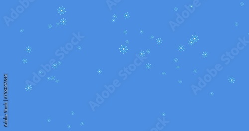 Digital image of multiple snowflakes icons falling against blue background