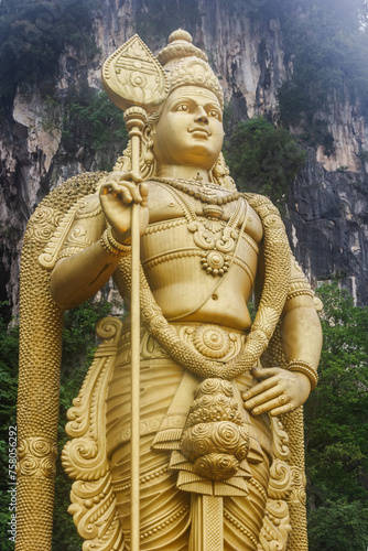 Lord Murugan with Vel at Batu Caves, Murugan Temple. Big golden Murugan statue at Batu Caves, the most popular tourist attraction in Malaysia.